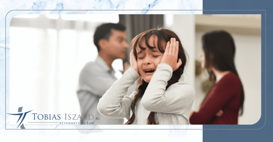 girl crying in front of fighting parents